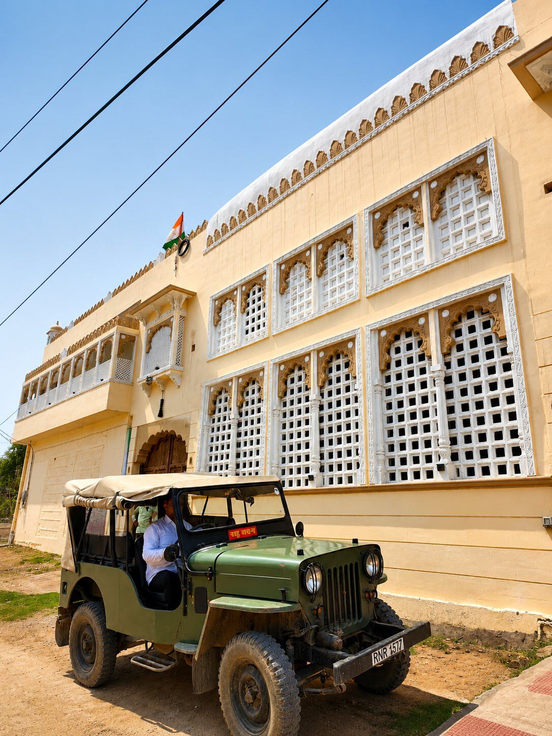 Vintage jeep outside the latticed facade