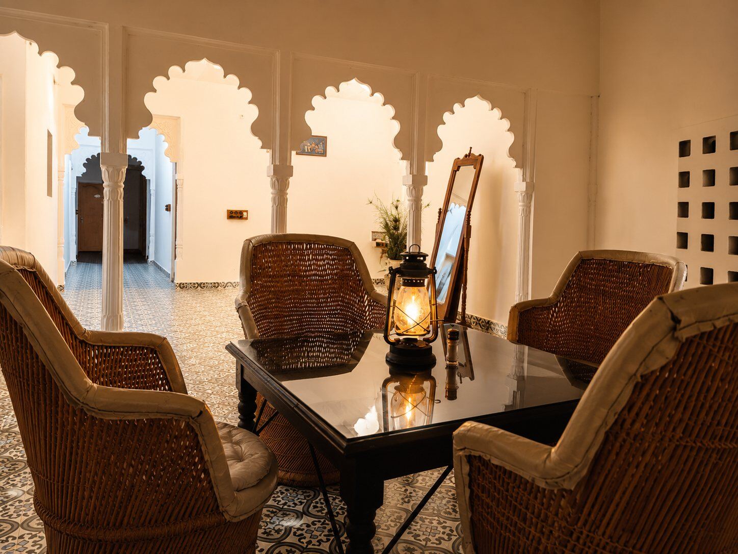 Wicker seating beneath scalloped arches