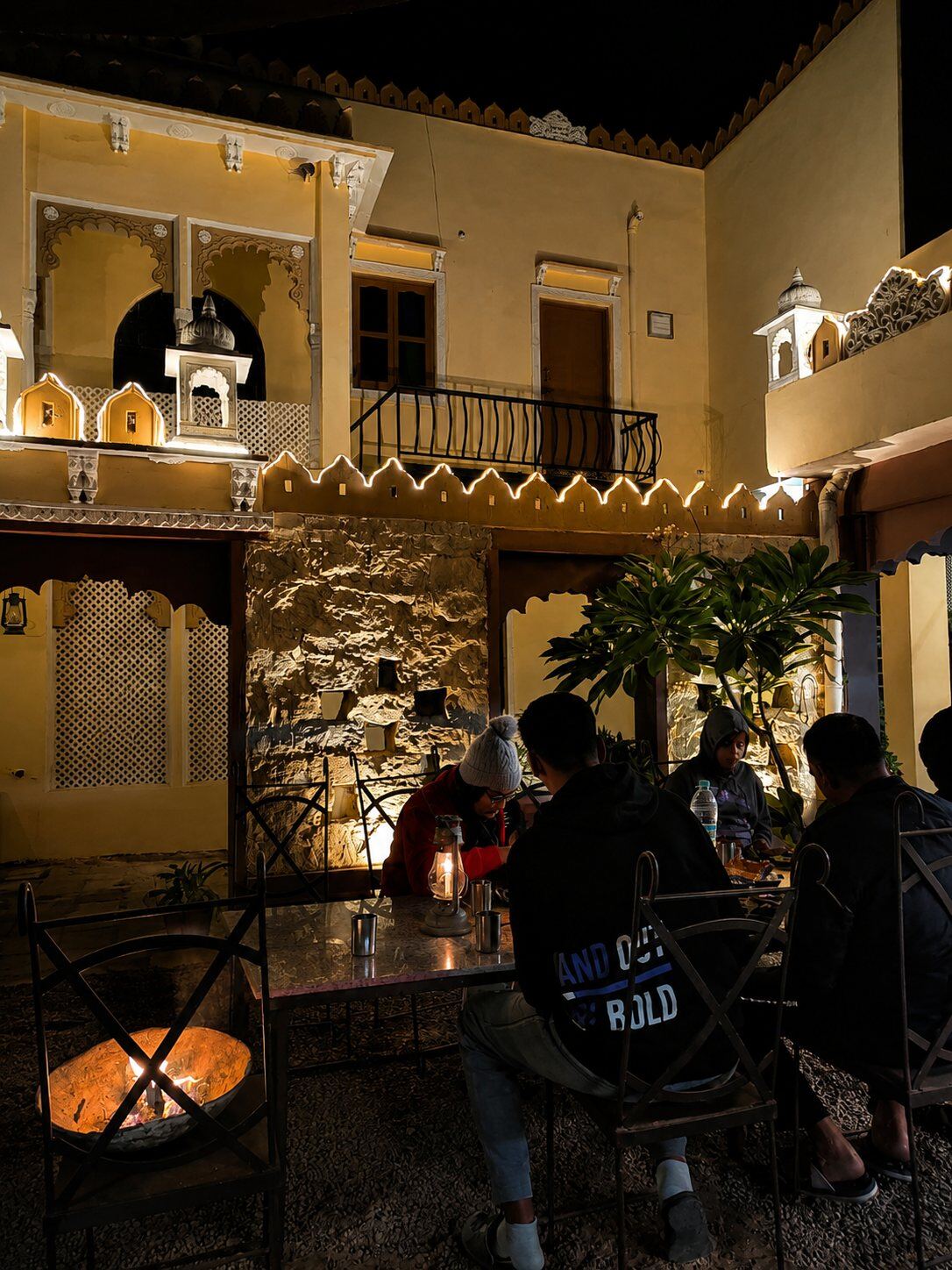 Guests dining by lantern light