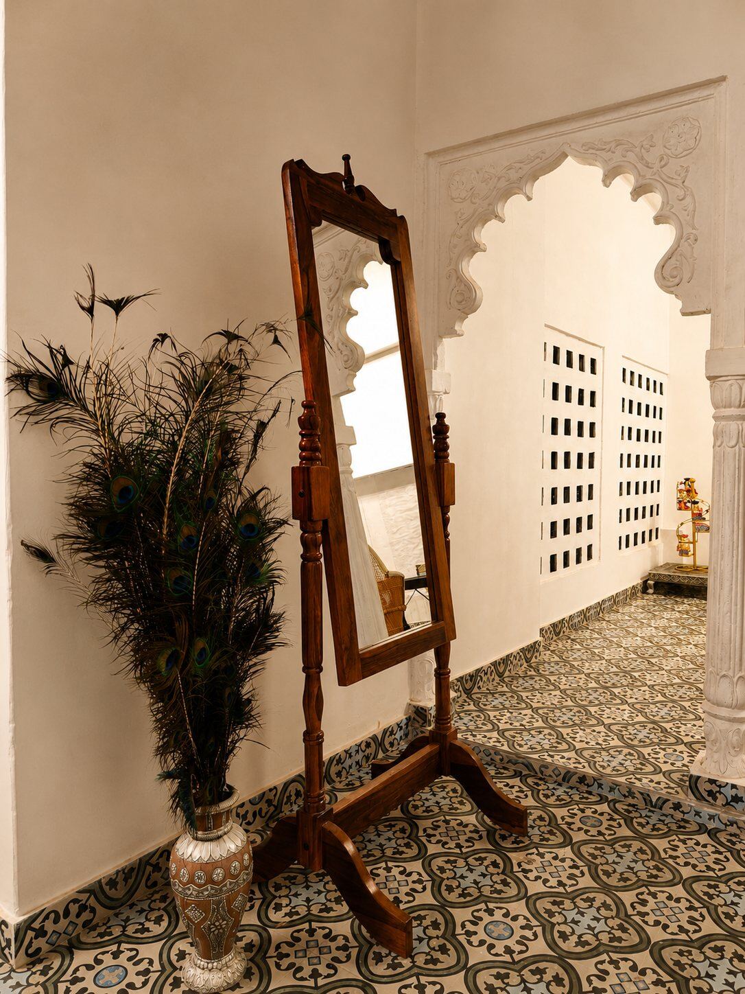 Antique standing mirror with peacock feathers