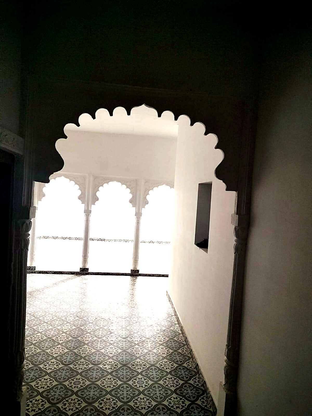 Scalloped archway leading to a terrace