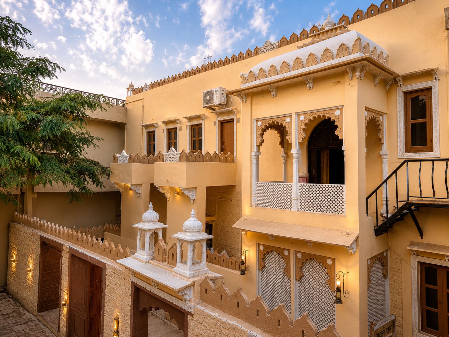 Golden hour view of the Garh Madan haveli courtyard and balconies