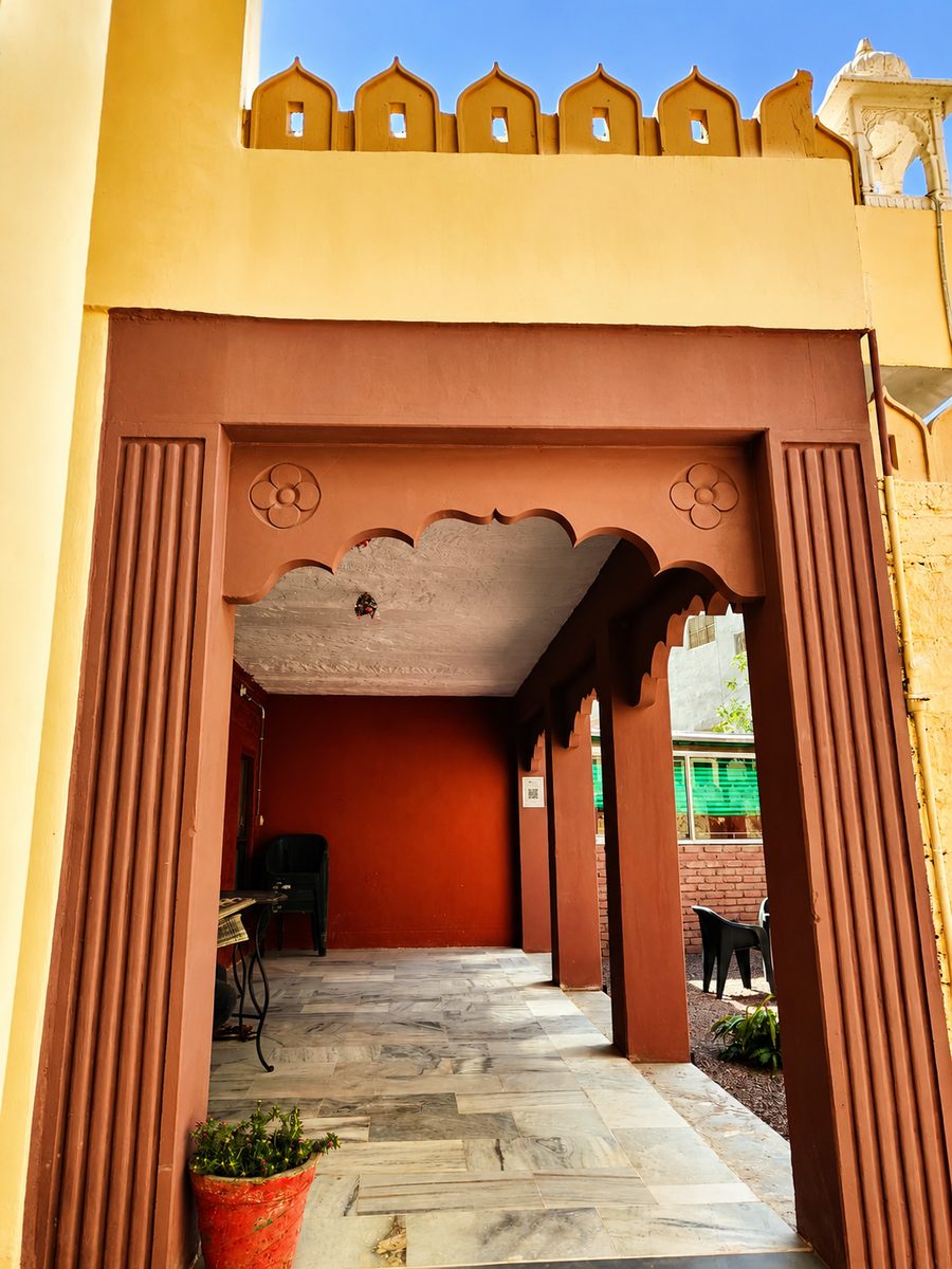 Dareechi, a shaded tea corner beneath jharokha windows at Garh Madan